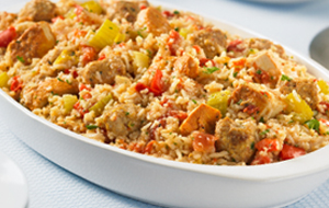 Chick and sausage jambalaya in a white casserole dish