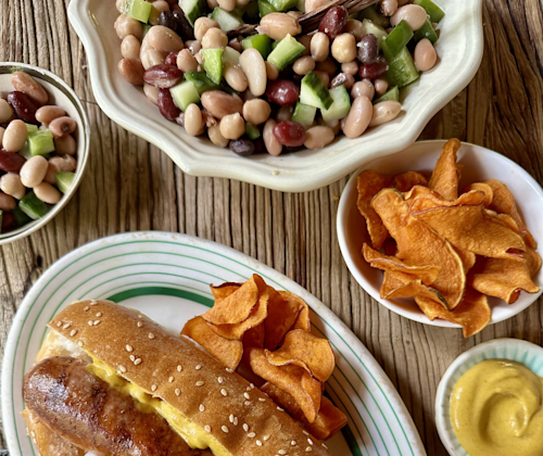 three bean salad with onions and pepper in white and blue bowl