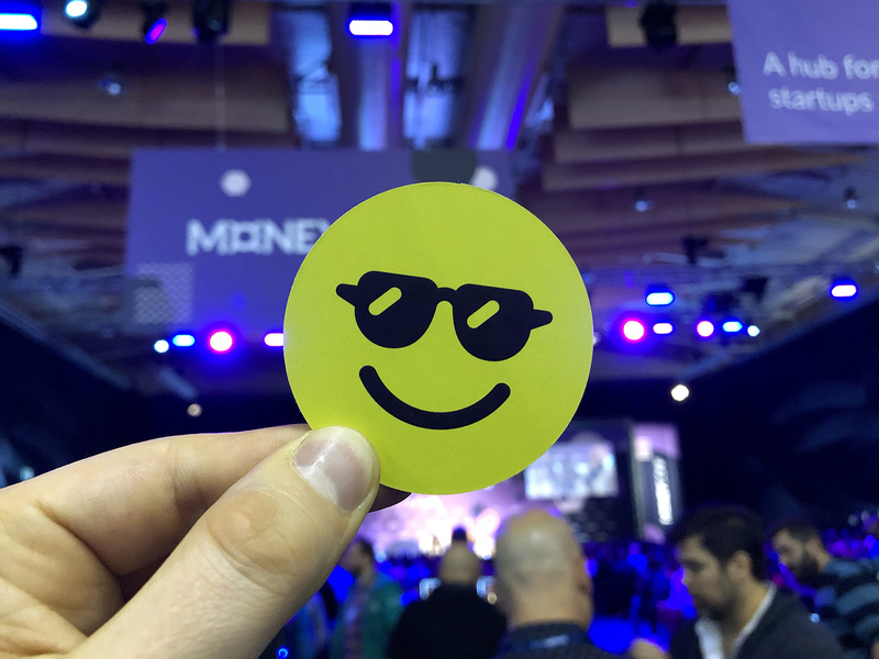Just a smiling Stickerbox logo with the Web Summit in the background