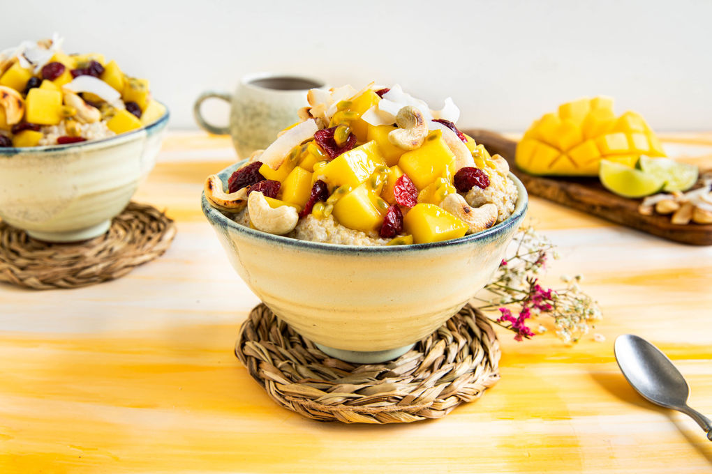 Ontbijtbowl van kokosquinoa met mango, passievrucht en cashewnoten
