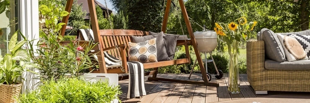 Een schommelstoel op het terras in de tuin | Un fauteuil à bascule sur la terrasse dans le jardin