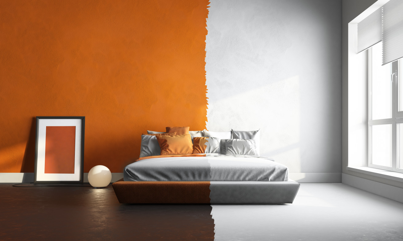 Een slaapkamer met een bed waarvan de muren oranje en wit zijn | Une chambre avec un lit dont les murs sont orange et blanc