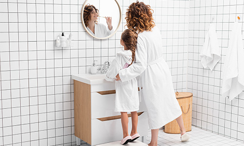 Femme et enfant se brossant les dents dans une salle de bains | Vrouw en kind poetsen hun tanden in een badkamer