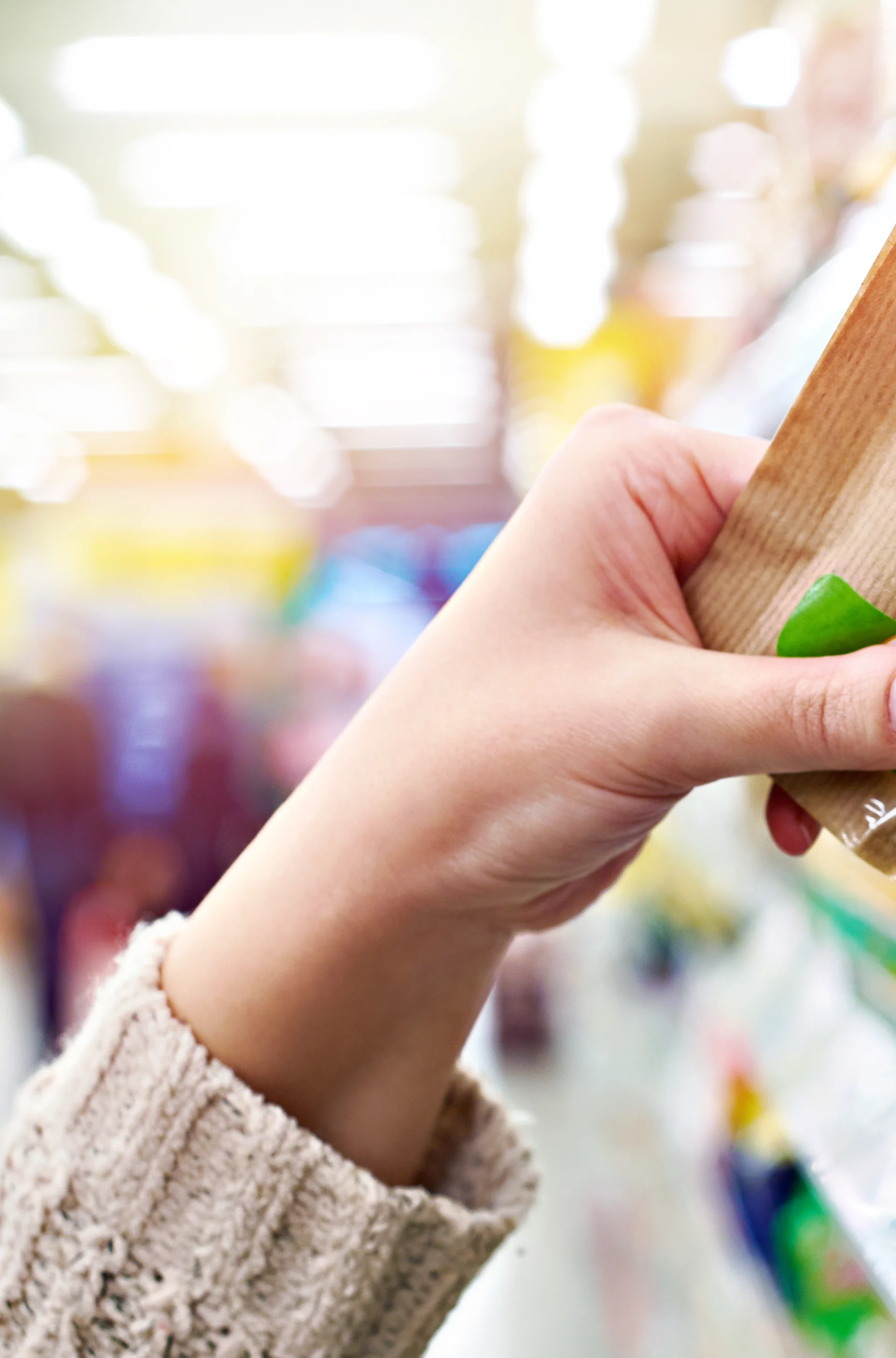 Customer selecting packaged almonds in a retail aisle, with flexible food packaging Customer selecting packaged almonds in a retail aisle, with flexible food packaging