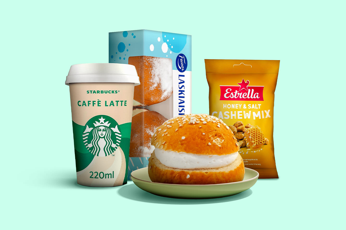 Herkullinen välipalakokonaisuus: noutokahvi, täytetty pulla, Fazer-laskiaispulla ja Estrellan pähkinäsekoitus vihreällä taustalla.