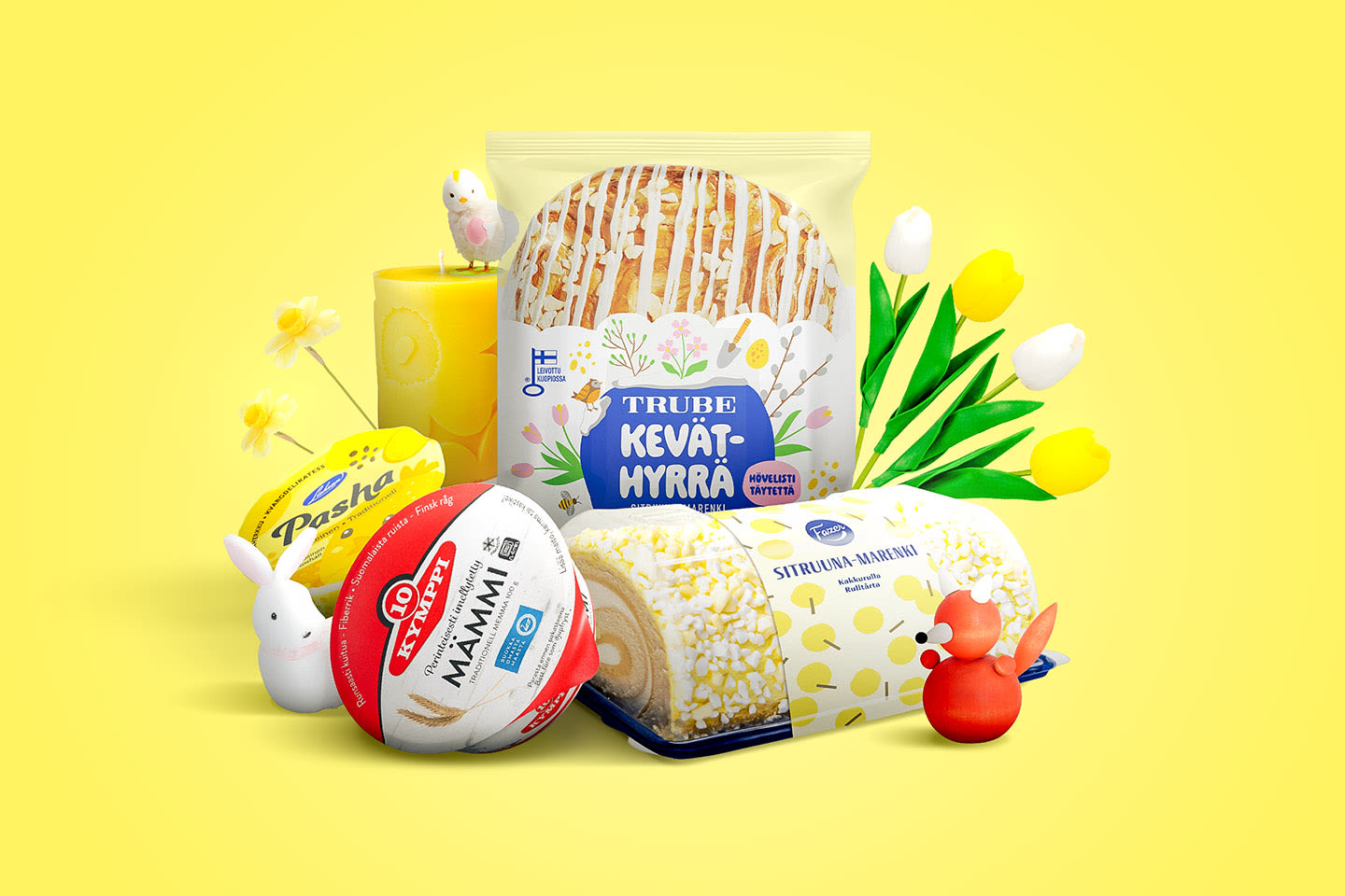 Keväisiä herkkuja keltaisella taustalla: Trube-keväthyrrä, kääretorttu, mämmi ja pasha sekä tulppaaneja ja pääsiäiskoristeita.