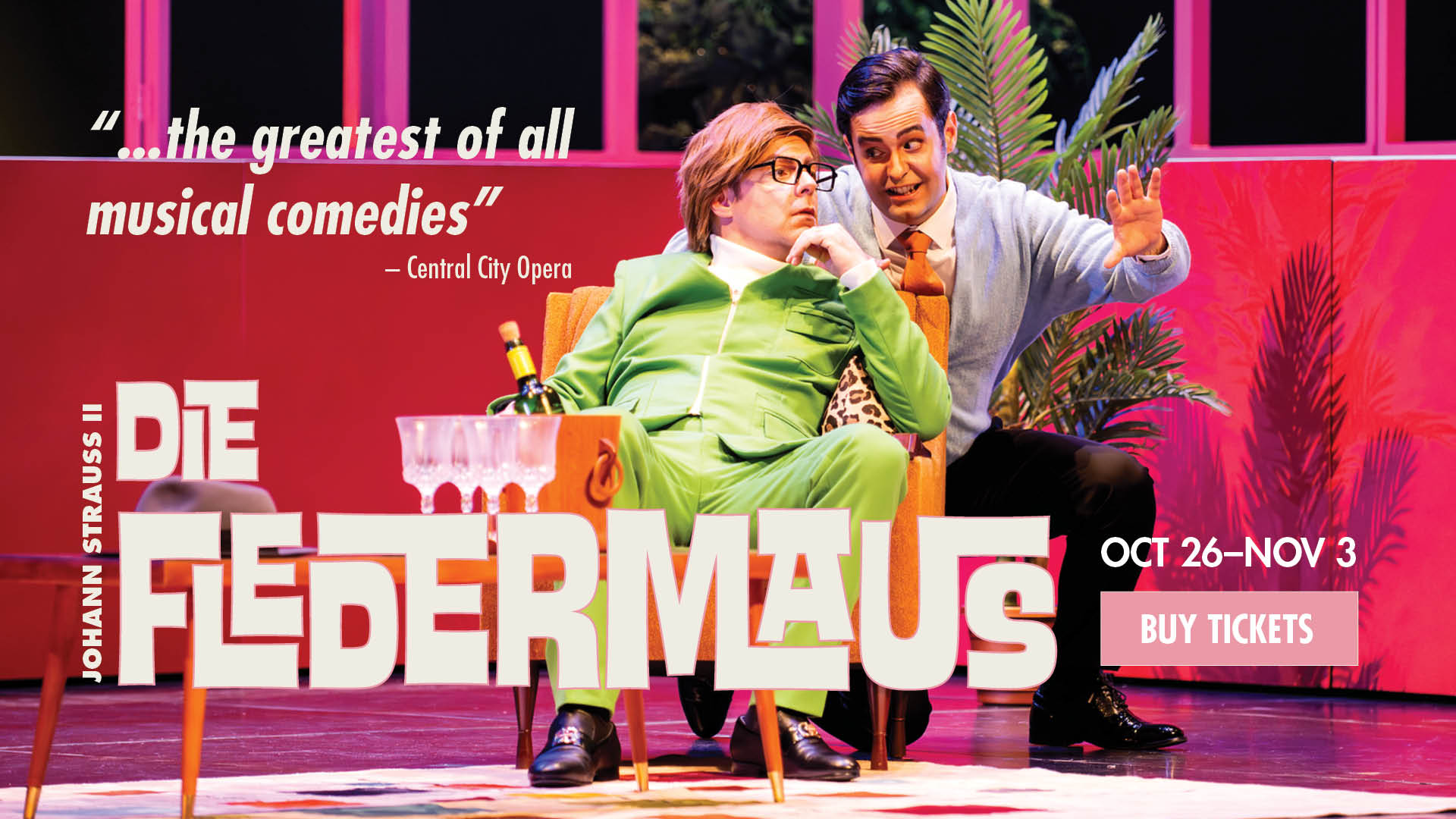 A scene from Die Fledermaus with two men in conversation near a table with a champagne bottle and glasses. Text overlaying the image says: "Die Fledermaus", "Oct 26-Nov 3", "Buy tickets", and "...the greatest of all musical comedies" - Central City Opera. 