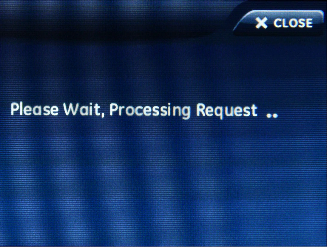 the Simon XTI screen stating please wait, processing request