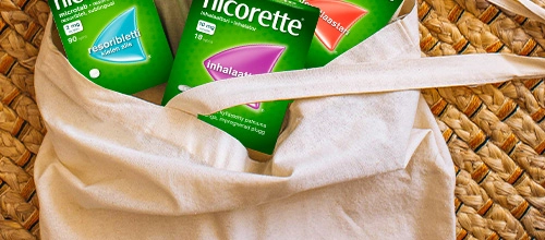 Bag containing Nicorette Microtabs, Nicorette Inhalator and Nicorette Invisipatch products