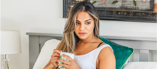 Woman sitting on a sofa with a mug