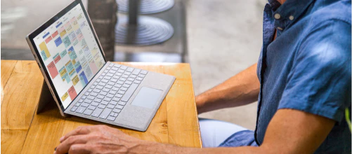 Man looking at a laptop computer on a desk