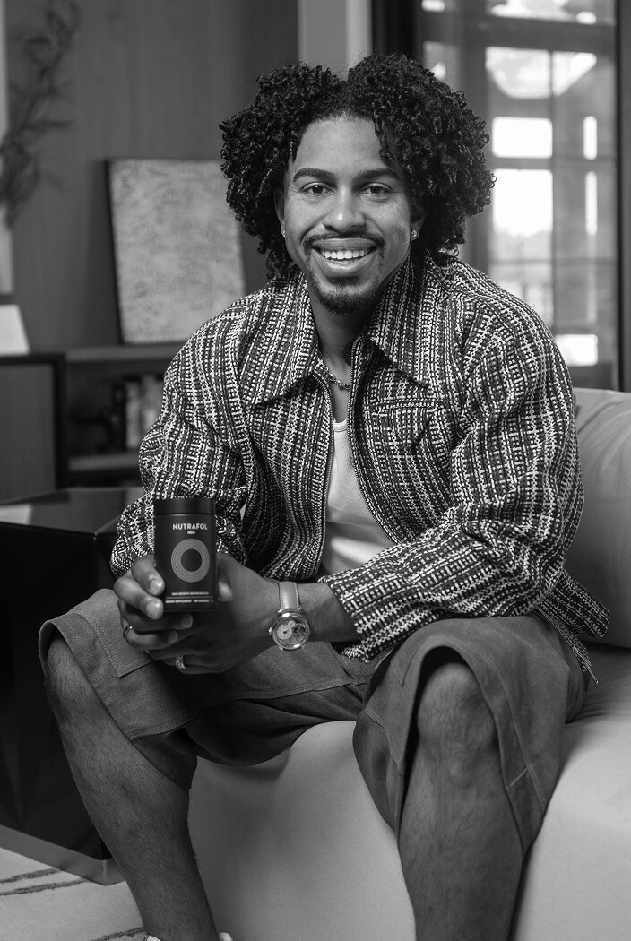 Francisco Lindor holding a Nutrafol Men bottle.