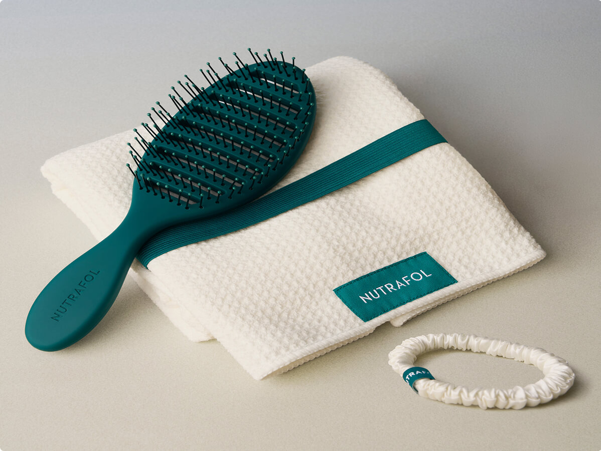 Nutrafol promotional gifts: waffle towel, wet brush, and silk scrunchie