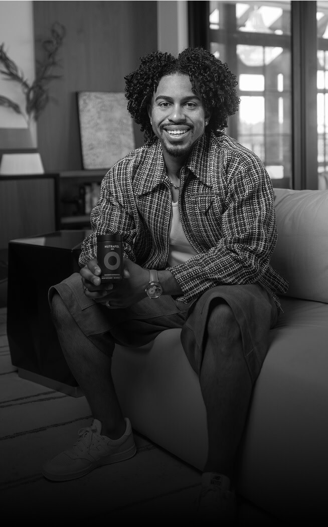 Francisco Lindor holding a Nutrafol Men bottle.