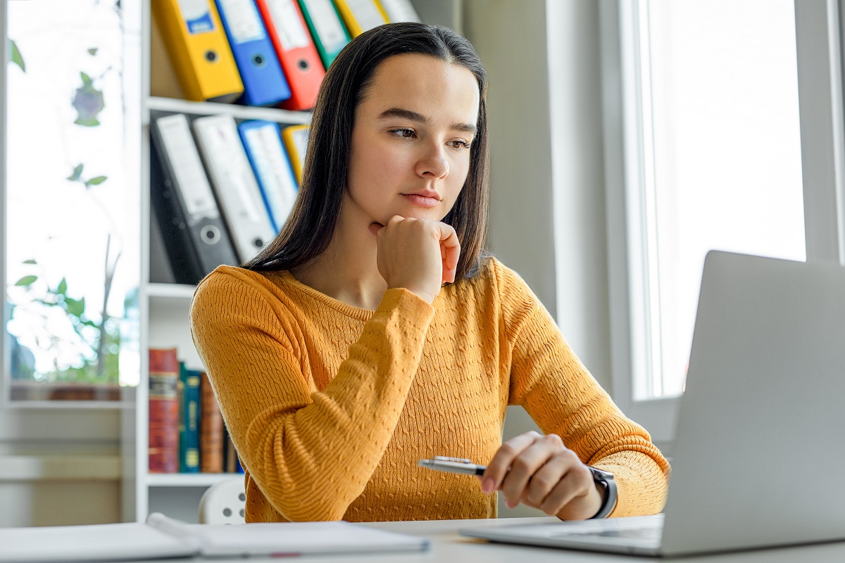 Woman visits with her doctor on a telemedicine call. 