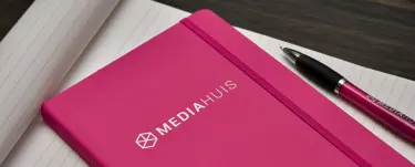 mediahuis pink notebook with pen