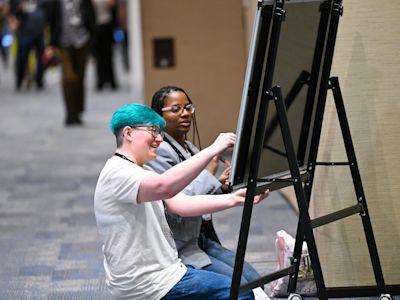 Two Replay 2026 attendees writing on a whiteboard