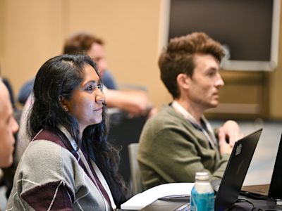 A Replay 2026 attendee watching a presentation
