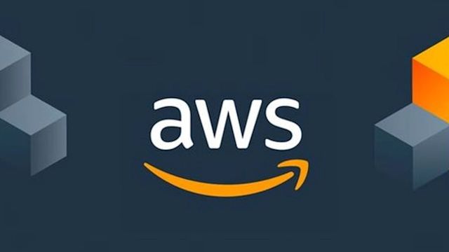 AWS logo with white text and orange smile on dark blue background, flanked by orange and gray 3D cube graphics.