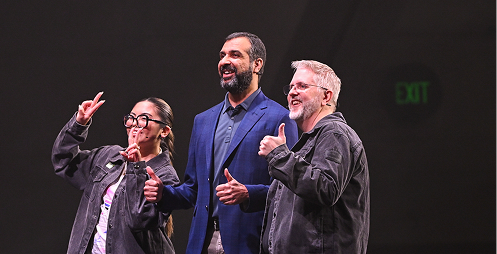 Two Temporal staff members posing with CEO Samar Abbas during the Replay 2026 keynote
