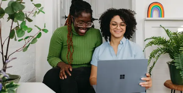 2 Women Working on Computer