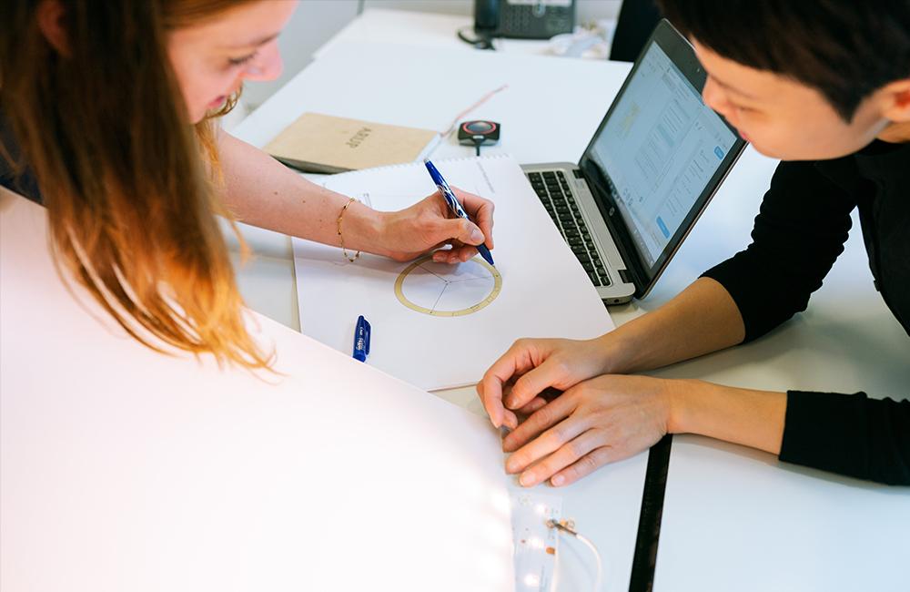 Two engineers working on a graph