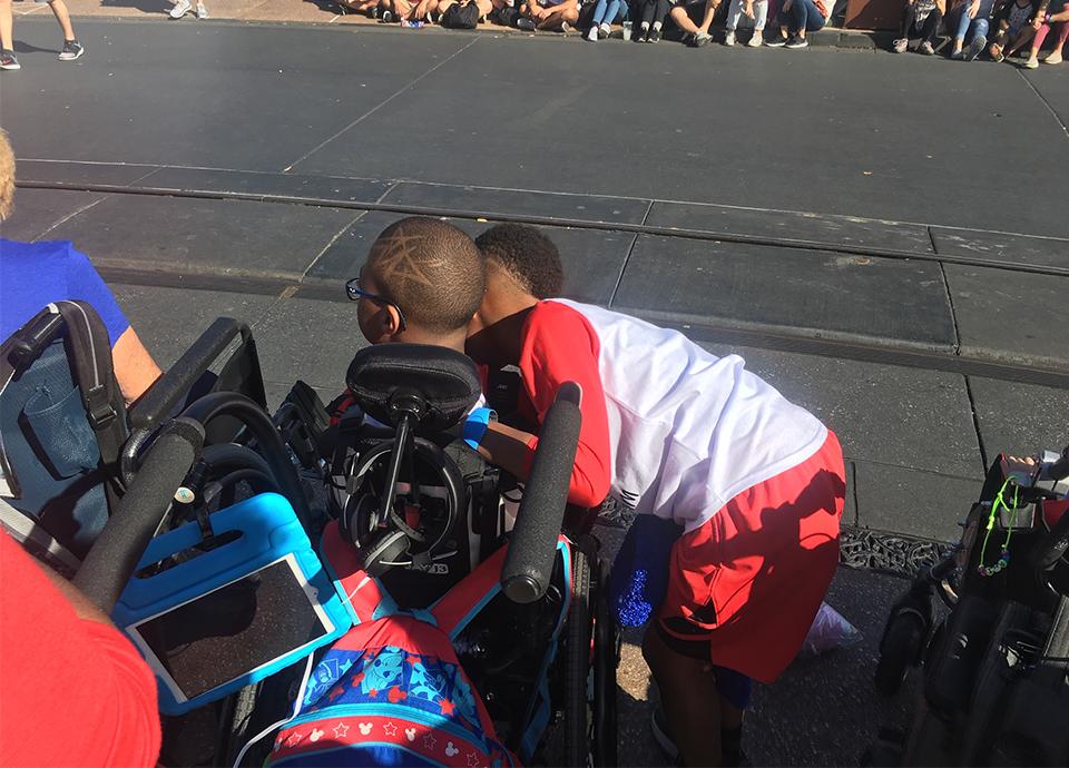Child with disability watching Disney parade