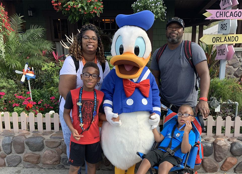 Tony Brown's family at Disney with Donald Duck