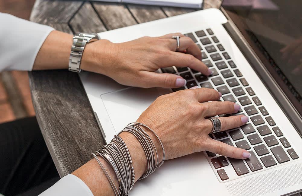 Woman typing on a laptop