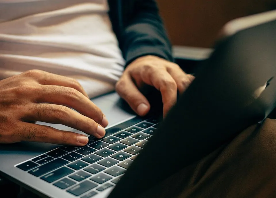 Person Typing on Laptop