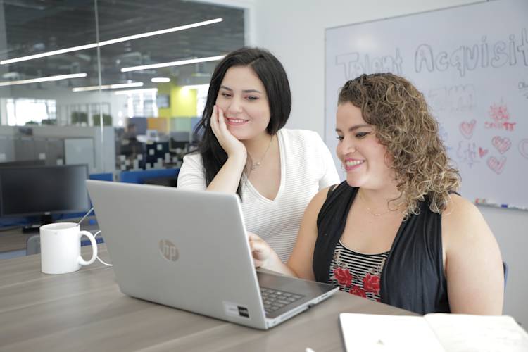 Nearshore Stock Photo - 2 people at laptop