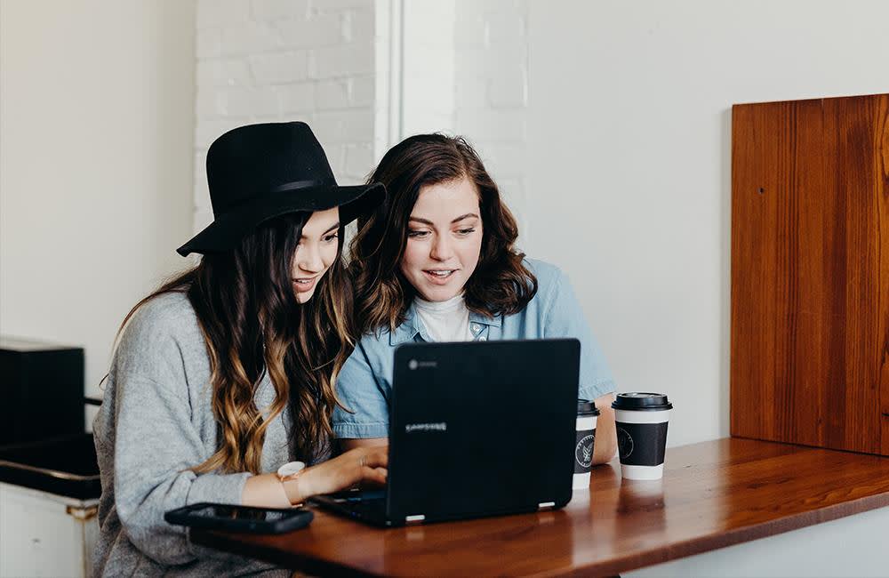 Two women looking at a laptop