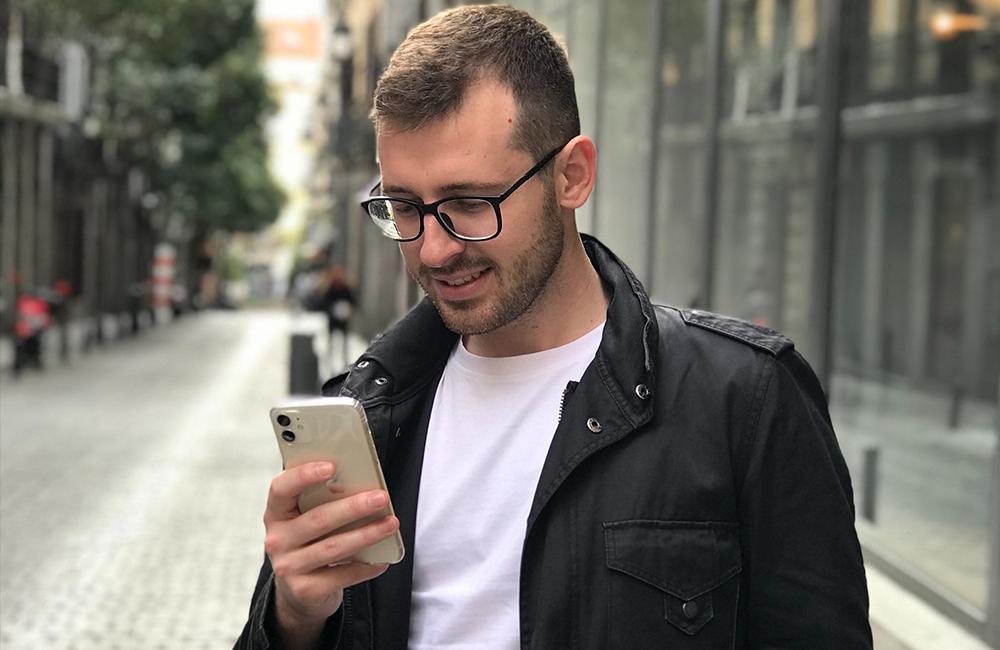 Man looking at his phone on the street