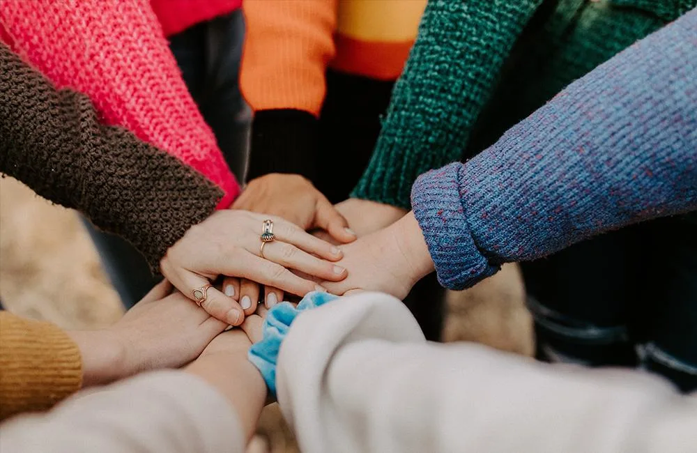 Team high five in a circle