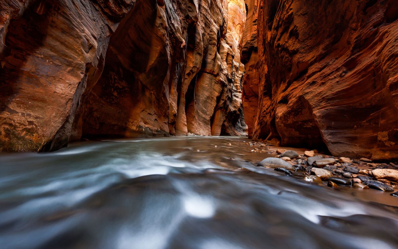 Red Rock Region | Photo Gallery | 0 - Zion National Park Hiking the Narrows in Zion National Park is an adventure that has to be experienced first-hand. You'll squeeze through a slot canyon and walk along a river bed.