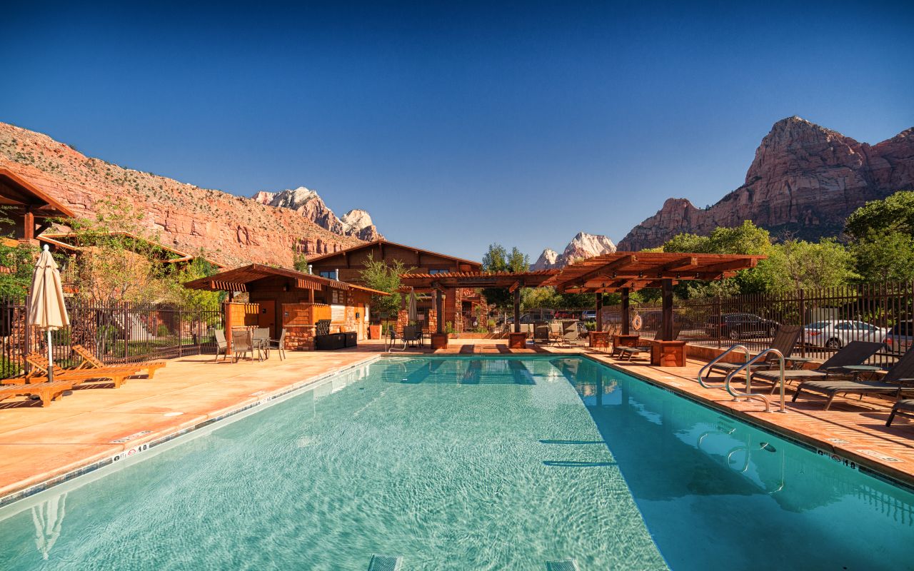 Cable Mountain Lodge | Photo Gallery | 7 - Pool & Spa After an exhilarating, adventure-filled day in the park, what could be better than relaxing by the edge of our pool or taking a rejuvenating soak in our jacuzzi spa, all framed against the stone cliff backdrop of the Watchman.