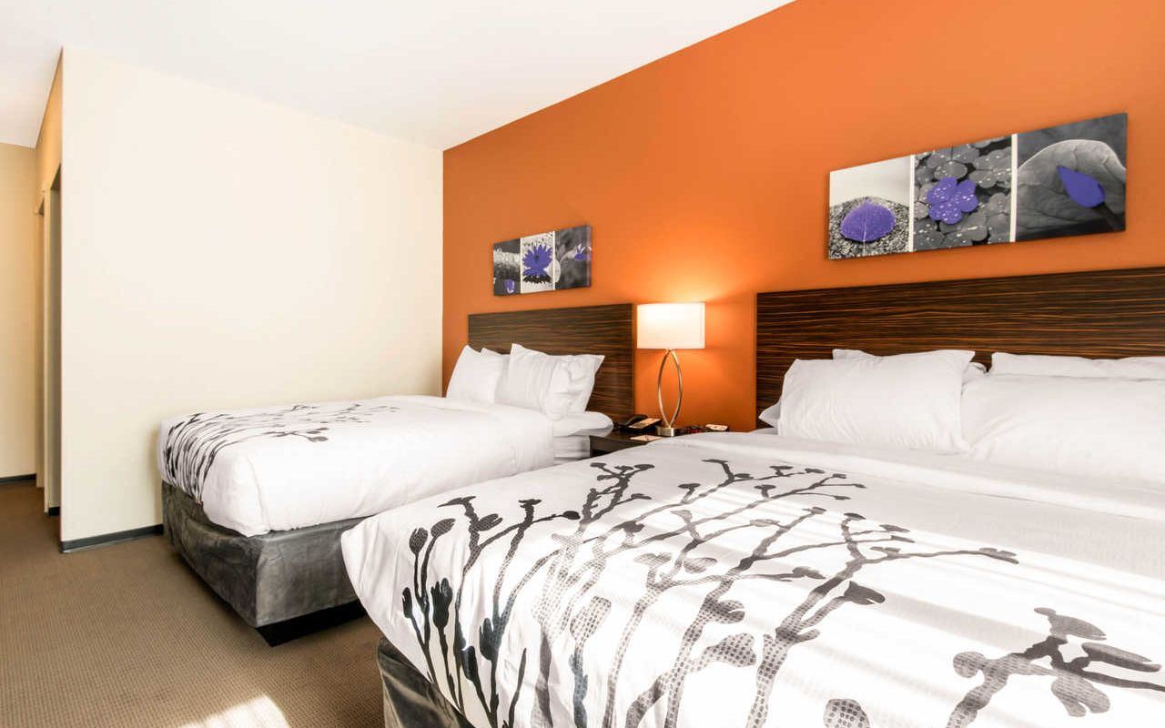 Sleep Inn & Suites Moab near Arches National Park | Photo Gallery | 2 - Double Queen Rooms Stay in this no smoking king bed room with free WiFi, a pillow-top mattress, flat screen TV, coffee maker, desk and more!