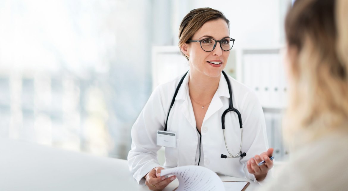 A doctor speaking to her patient in the hospital