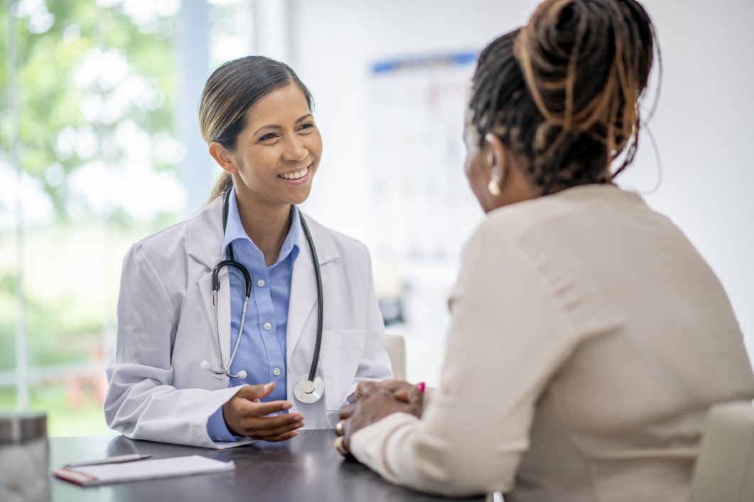 A female doctor talking with a patient