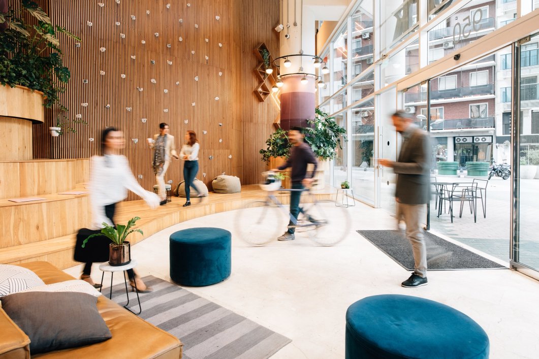 A modern office lobby with people passing through