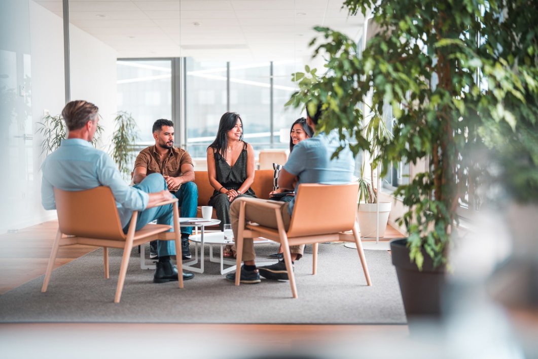 a group of colleagues discussing whole-person care at the office