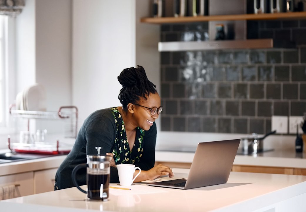 A woman working on the computer in her home