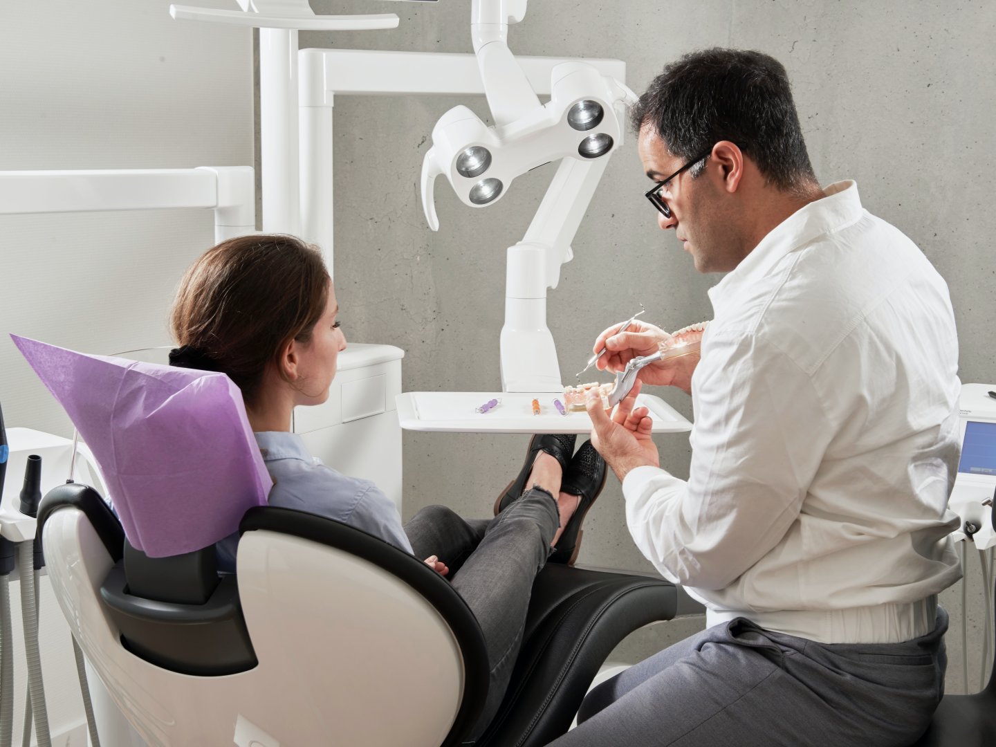 A dentist talking to a patient during an appointment.