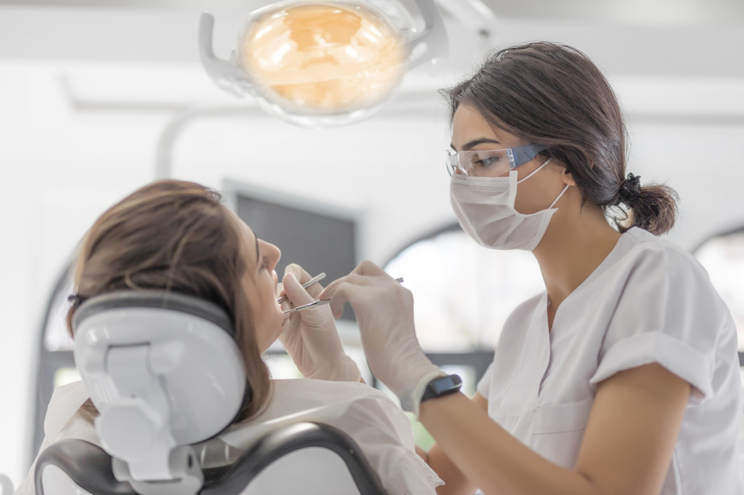 A female dentist examining a patient.