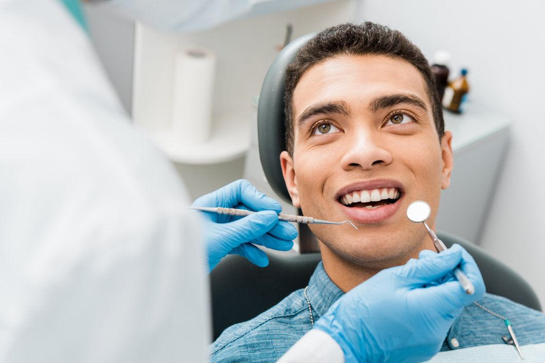 A man getting his teeth examined at the dentist