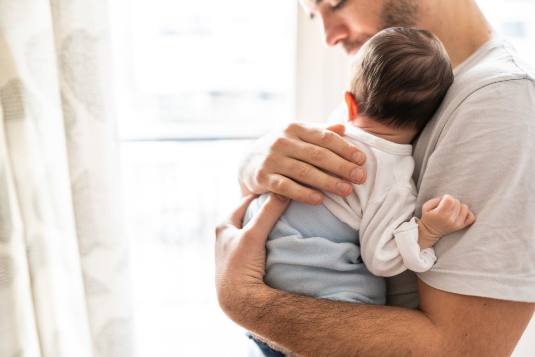 A father holding his newborn baby