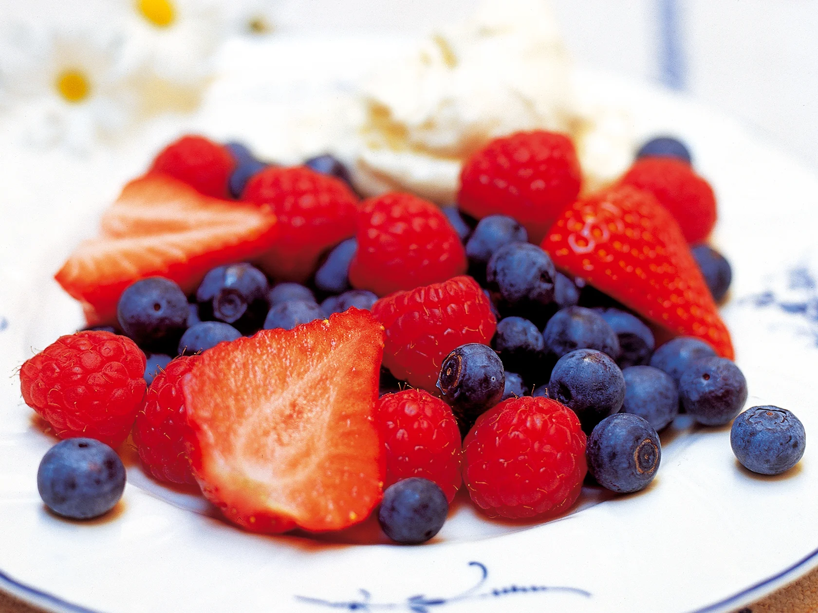 Tuoreita marjoja ja valkosuklaavaahtoa