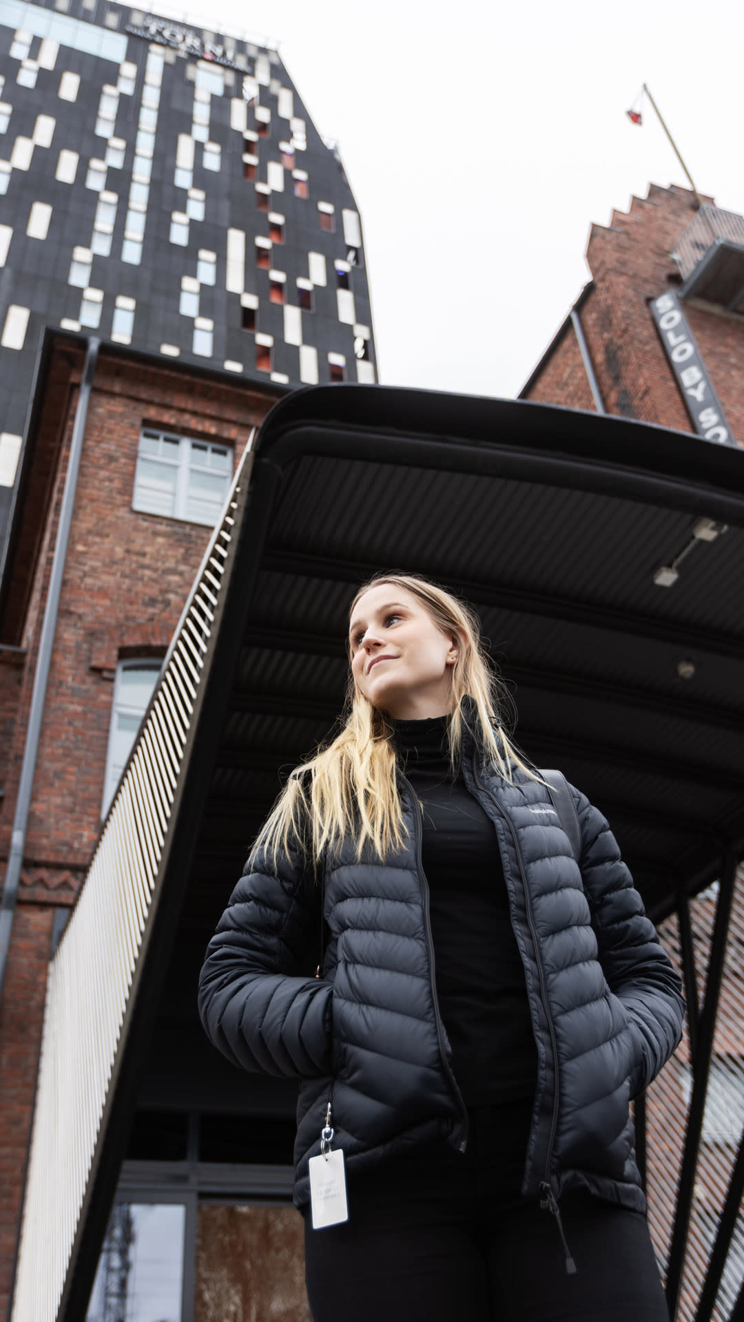 Johanna Sirviö kävelemässä ulkona. Taustalla näkyvä korkea rakennus on Solo Sokos Hotel Torni Tampere.