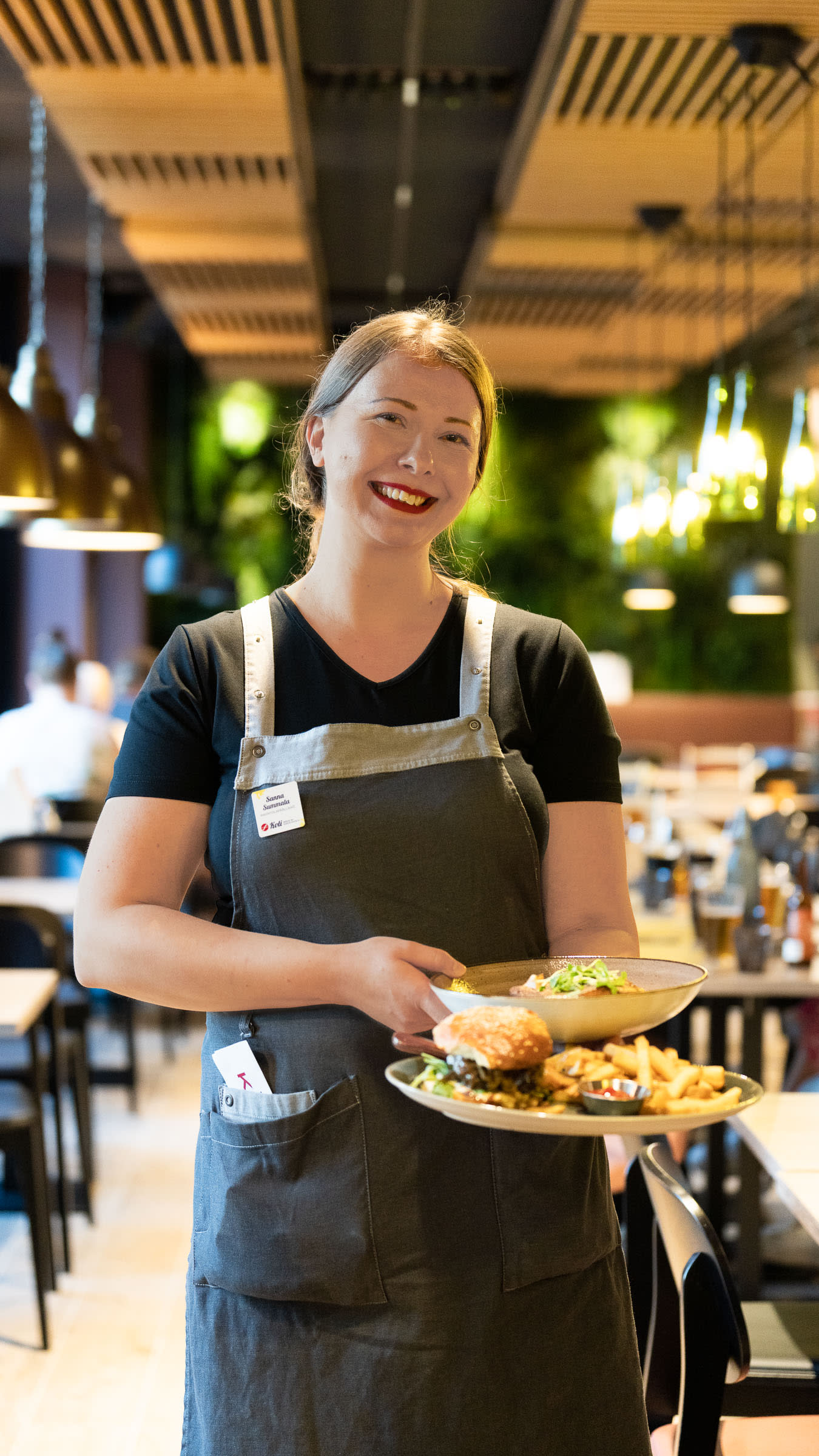 Ravintolatoimen päällikkö Sanna Summala tarjoilee ruokaa