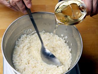 Lisää lientä ja viiniä pienissä erissä ja anna nesteen lisäysten välillä imeytyä riisiin. Kypsennä hyvällä lämmöllä. Risottoriisi kypsyy noin 18 minuutissa ja se saa jäädä kiinteäksi.